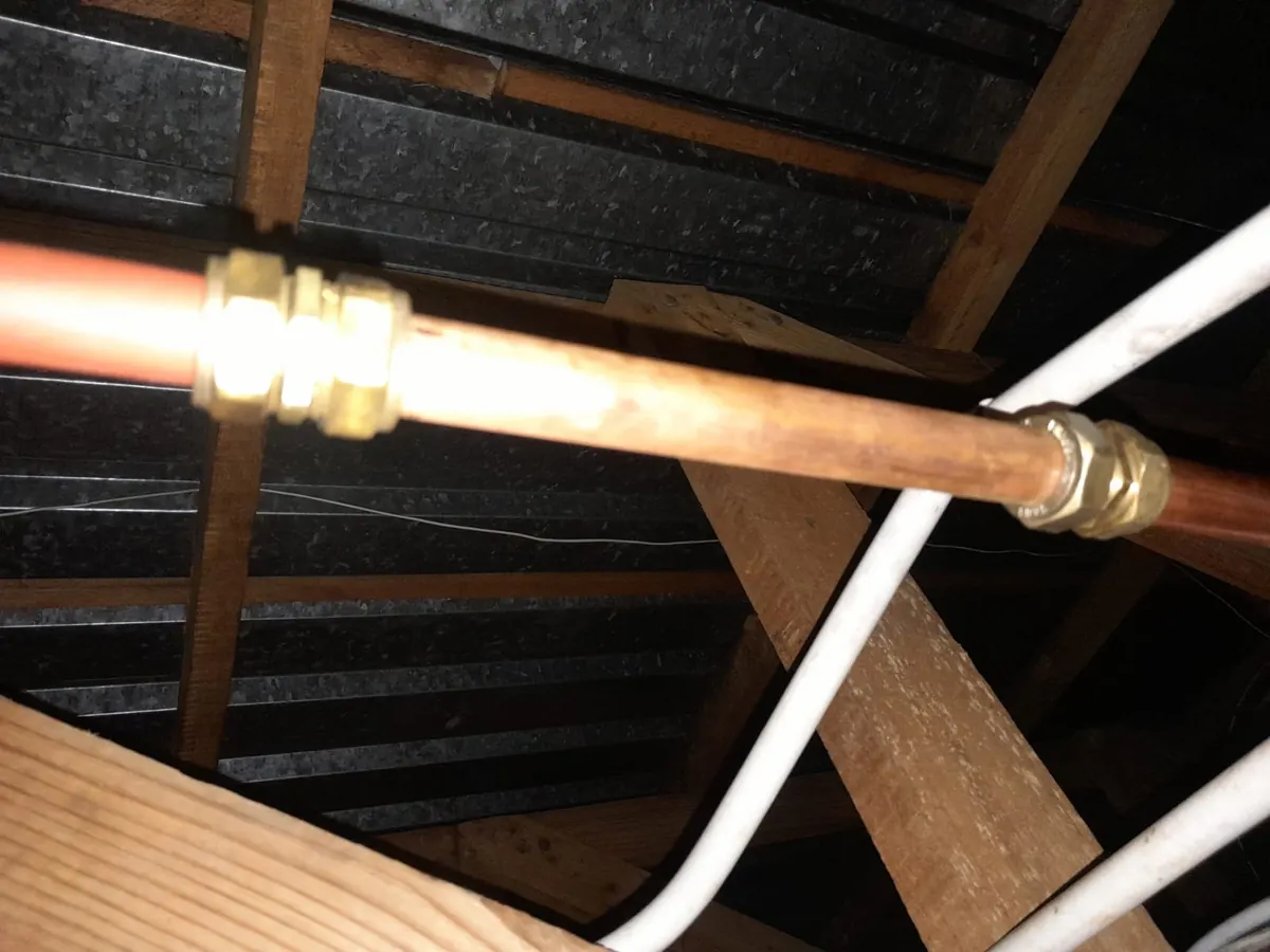 Burst pipe repair with damaged water line opened and repaired during emergency plumbing work.