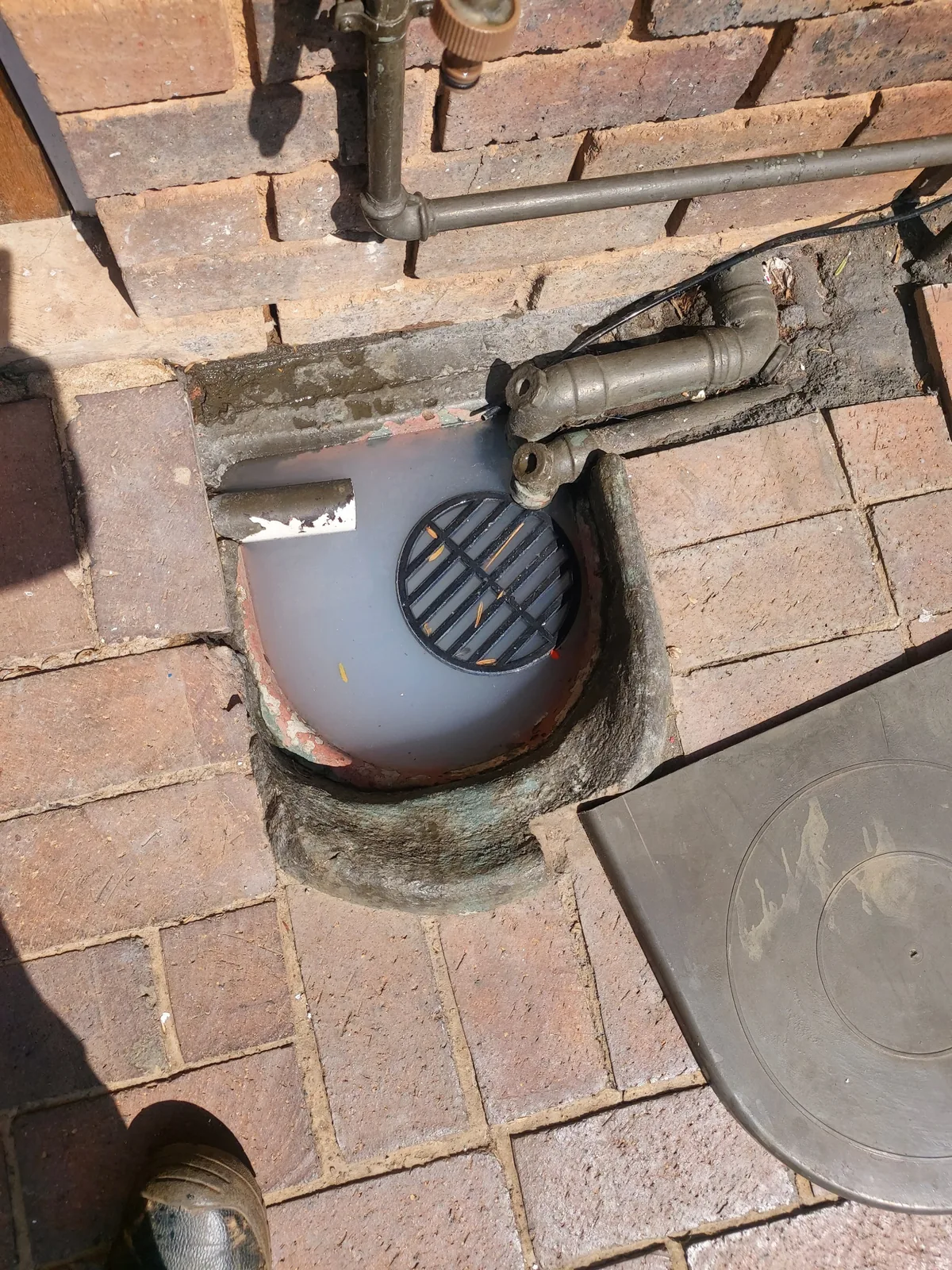 Overflowing outside gully requiring emergency Randburg plumbing attention.